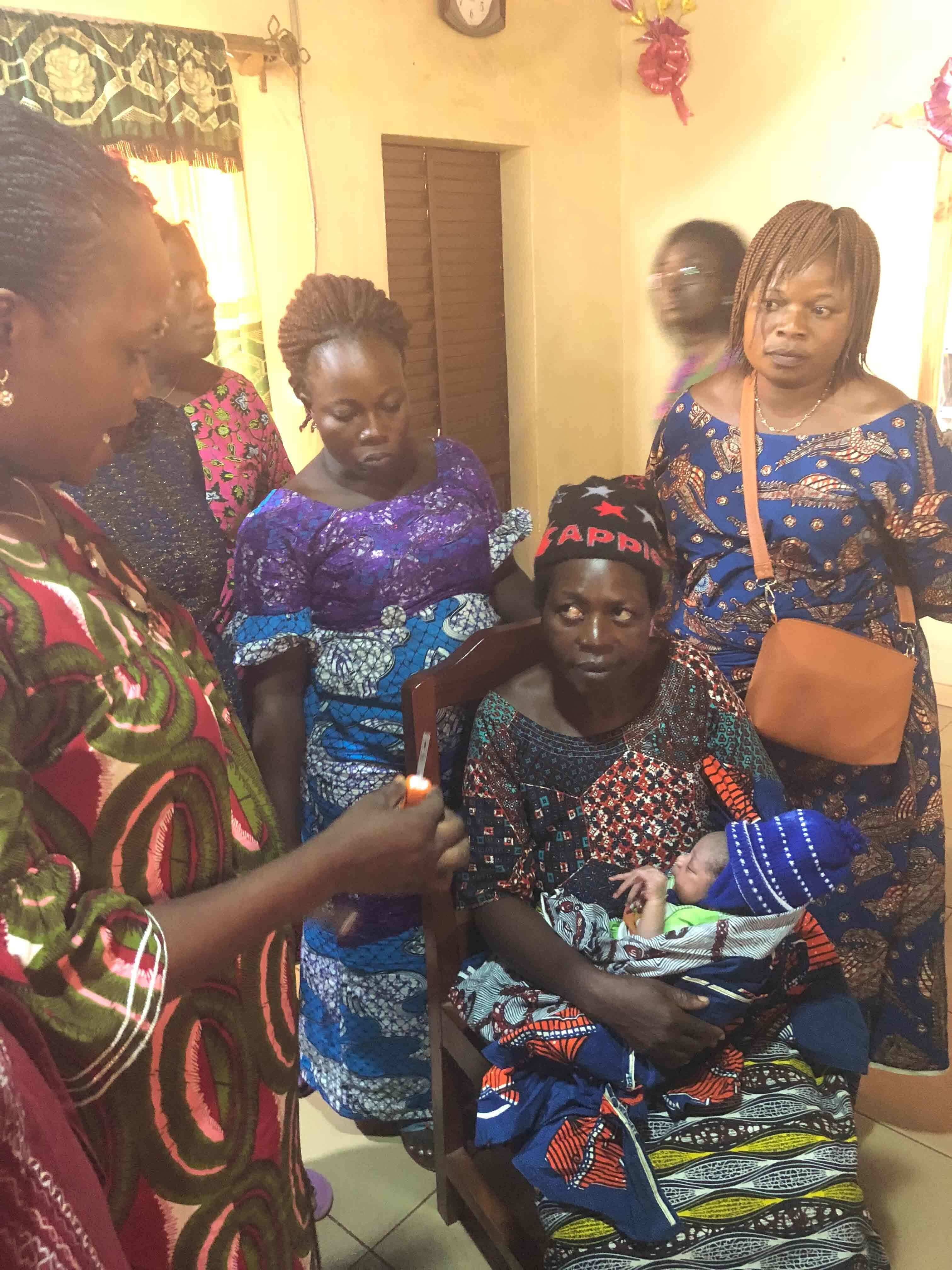 Benin — Health workers educating a mother on TempWatch
