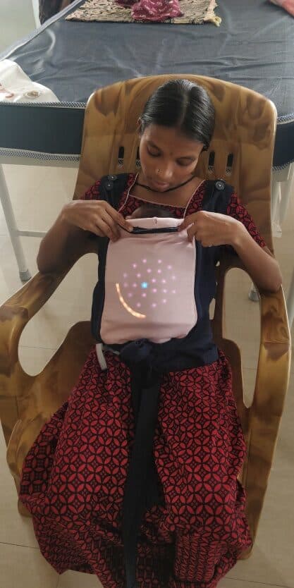 A mother wears KangaGrow during the Niloufer Hospital pilot study