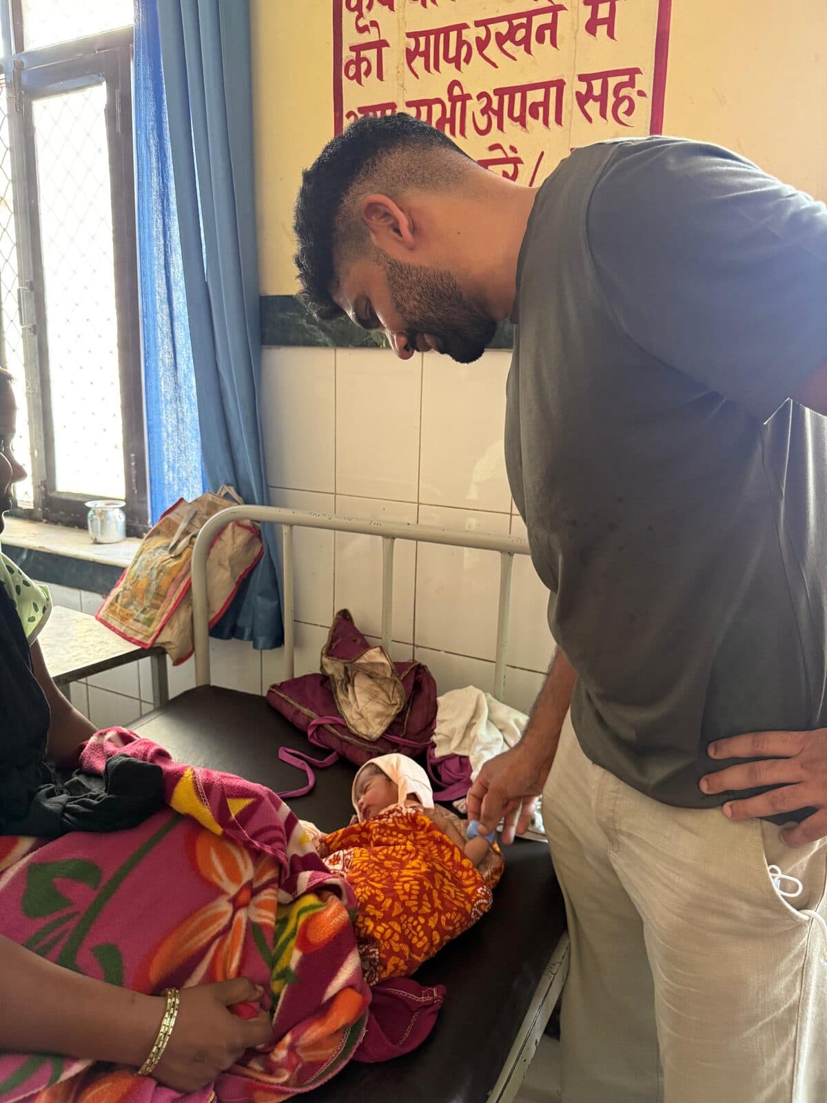 BEMPU's founder meets a mother and baby using TempWatch at the Dholpur site